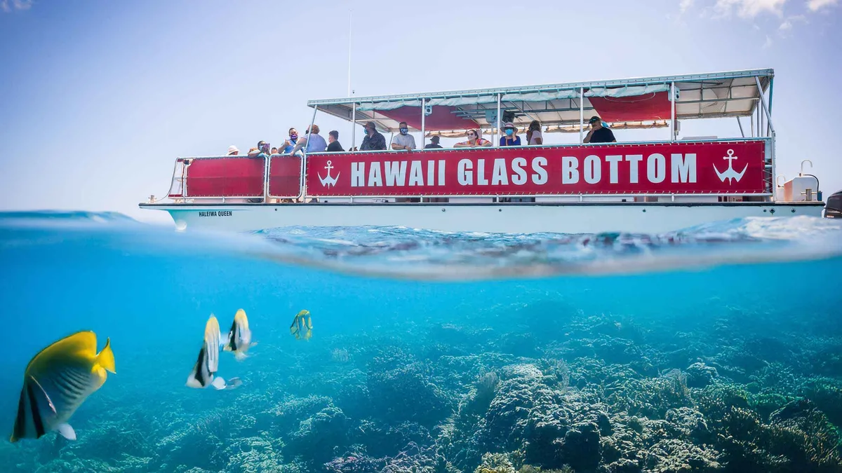 Glass-bottom boat Haleiwa Queen cruising the south shore reef on an Oahu boat tour off Honolulu, Hawaii