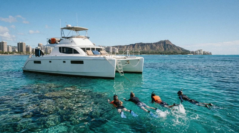 Catamaran moored at Turtle Canyon reef for snorkeling with green sea turtles on an Oahu boat tour off Waikiki, Hawaii